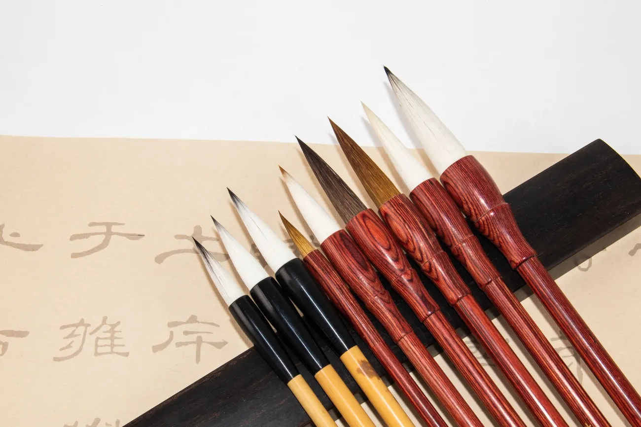 A row of Japanese calligraphy brushes