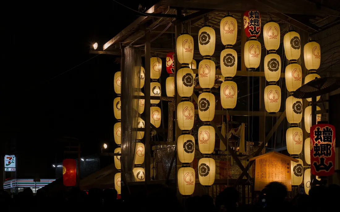Lanterns lit along a Japanese street at night