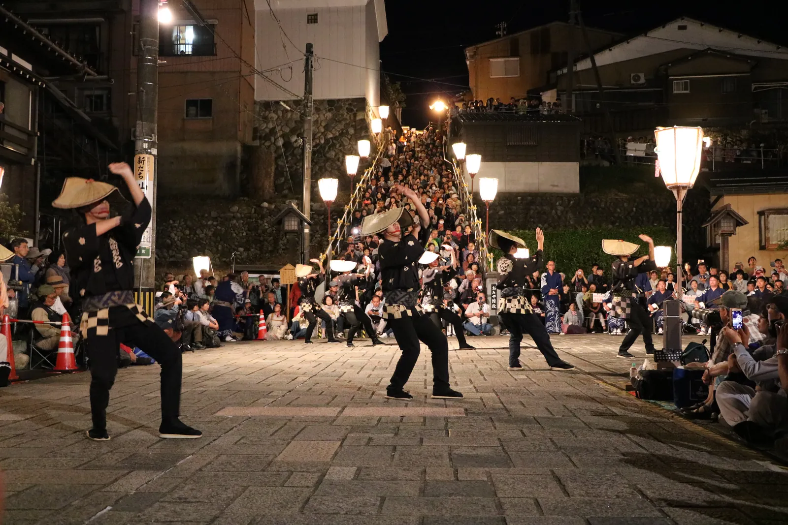 Owara dancers in amigasa straw hats under paper lanterns at night, Etchu Yatsuo