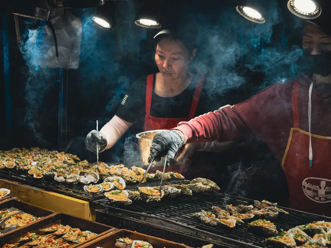 Seafood grilling over charcoal at a Japanese stall