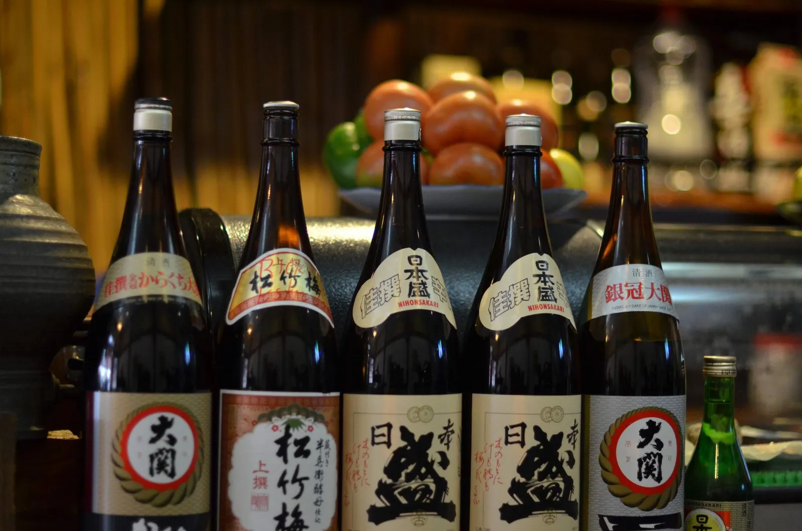 Bottles of Japanese shochu lined up in a bar