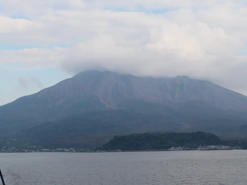 A ferry crossing to an active volcano from a Japanese port city