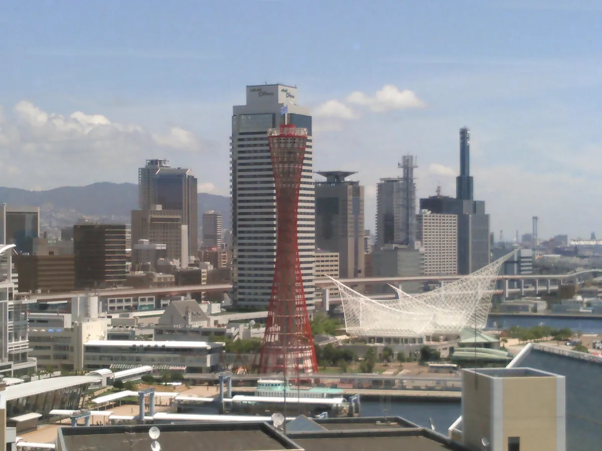 Kobe Port Tower and the white sail-shaped roof of the Maritime Museum, with the city behind