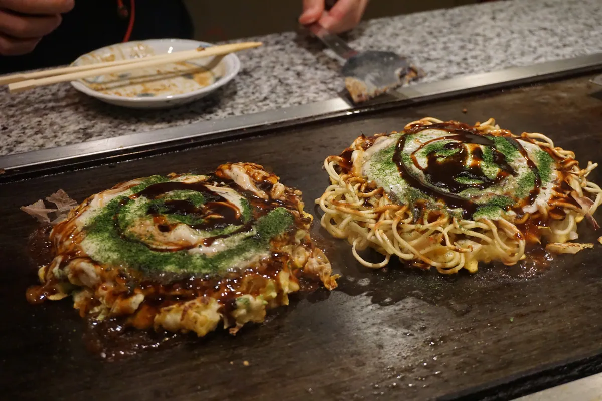 Okonomiyaki cooking on teppan Osaka