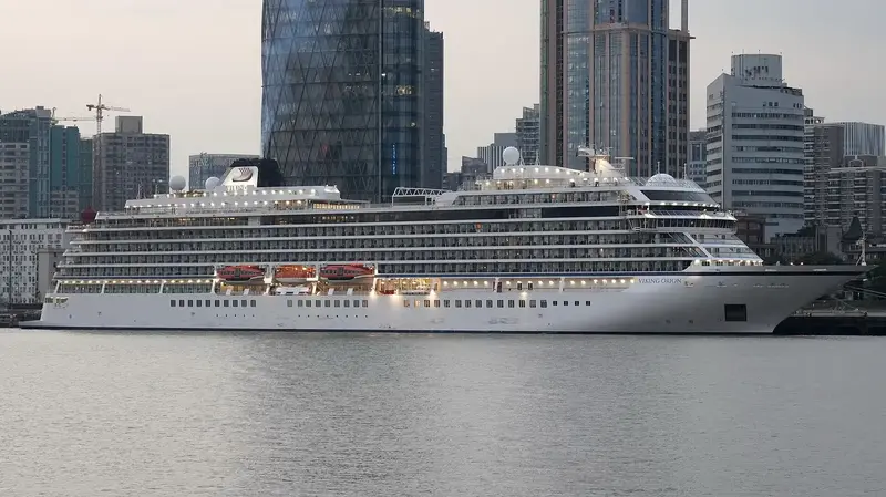 A cruise ship alongside a city waterfront