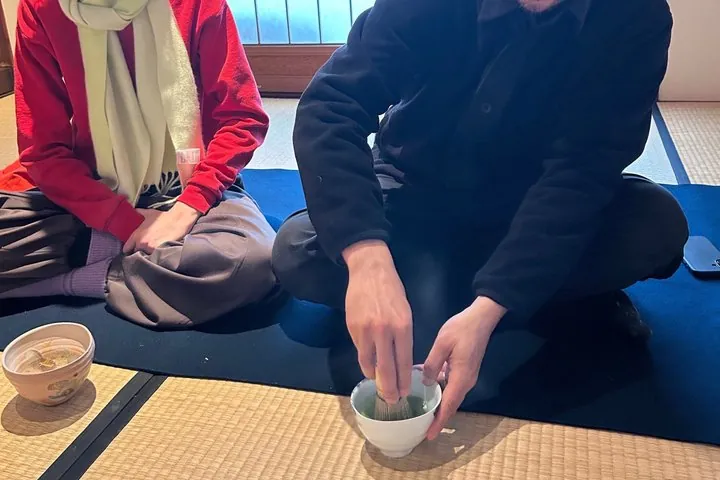 Guest hands whisking matcha (hands-on moment)